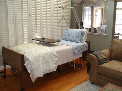 hospital bed with trapeze and hospital bed table