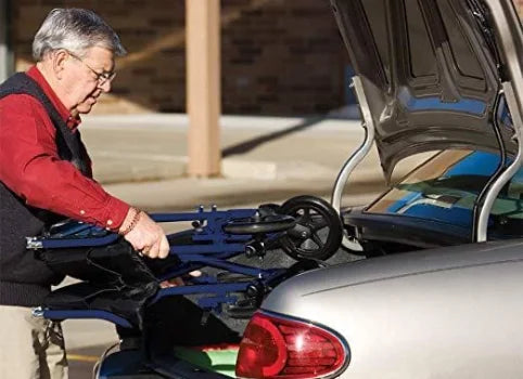 Man setting up a bike rack on a car in a parking lot