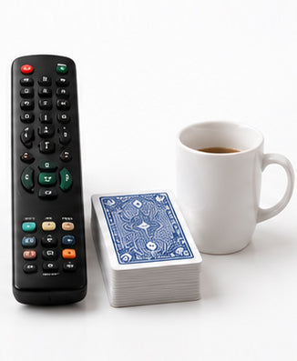 Portable Nebulizer size compared with a TV remote, deck of cards, and coffee mug