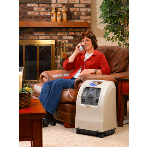 Oxygen concentrator being used by a woman at home