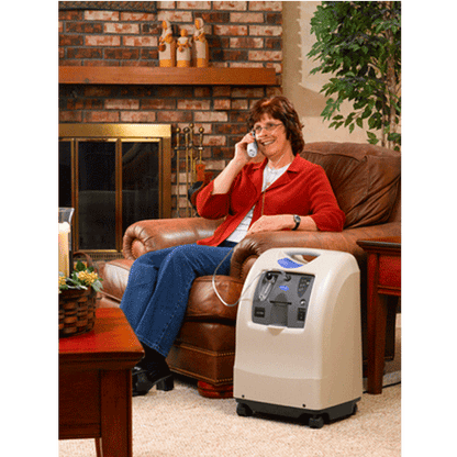 Oxygen concentrator being used by a woman at home